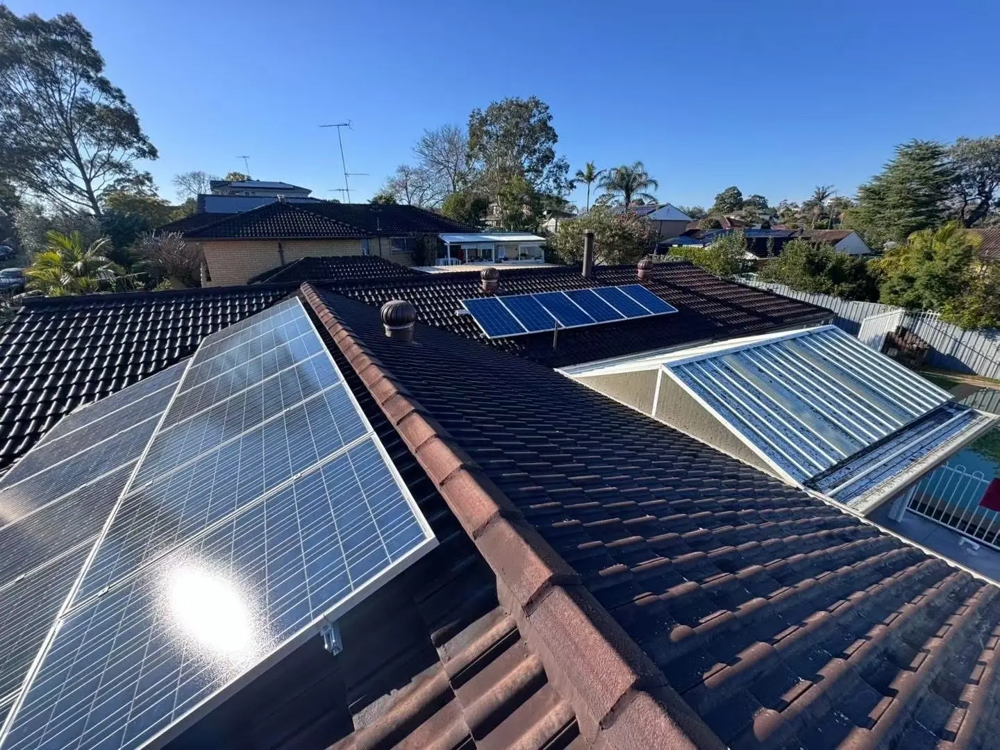 Wide view of the concrete tile roof and solar panels before restoration